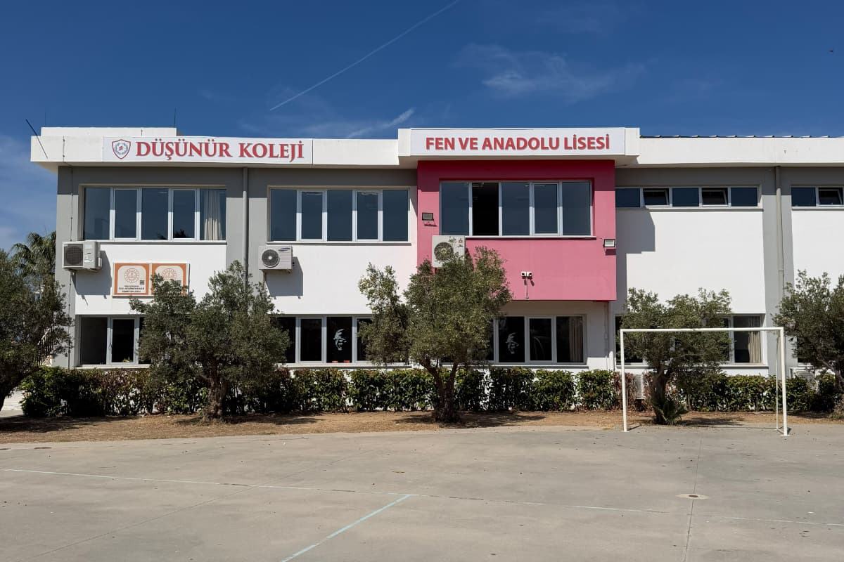 Güzelbahçe Fen Lisesi binası, tabelaları ve önündeki spor sahası