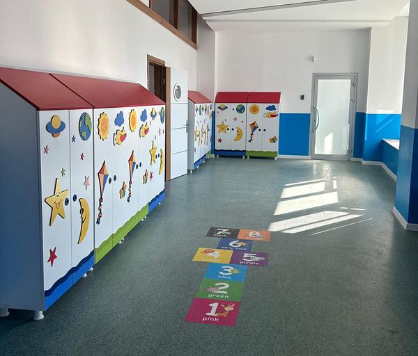 Renkli dolaplı anaokulu koridoru ve yer seksek oyunu